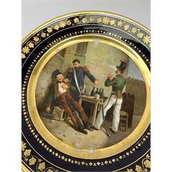19th century Rihouet Paris porcelain cabinet plate, decorated with a central panel illustrating three French soldiers around a bottle laden table, one surveying a note, within a dark blue gilt detailed border, with French inscription verso, and red printed mark Rihouet Rue de la Paix A Paris and green fish mark, possibly for Perche, D23cm 



