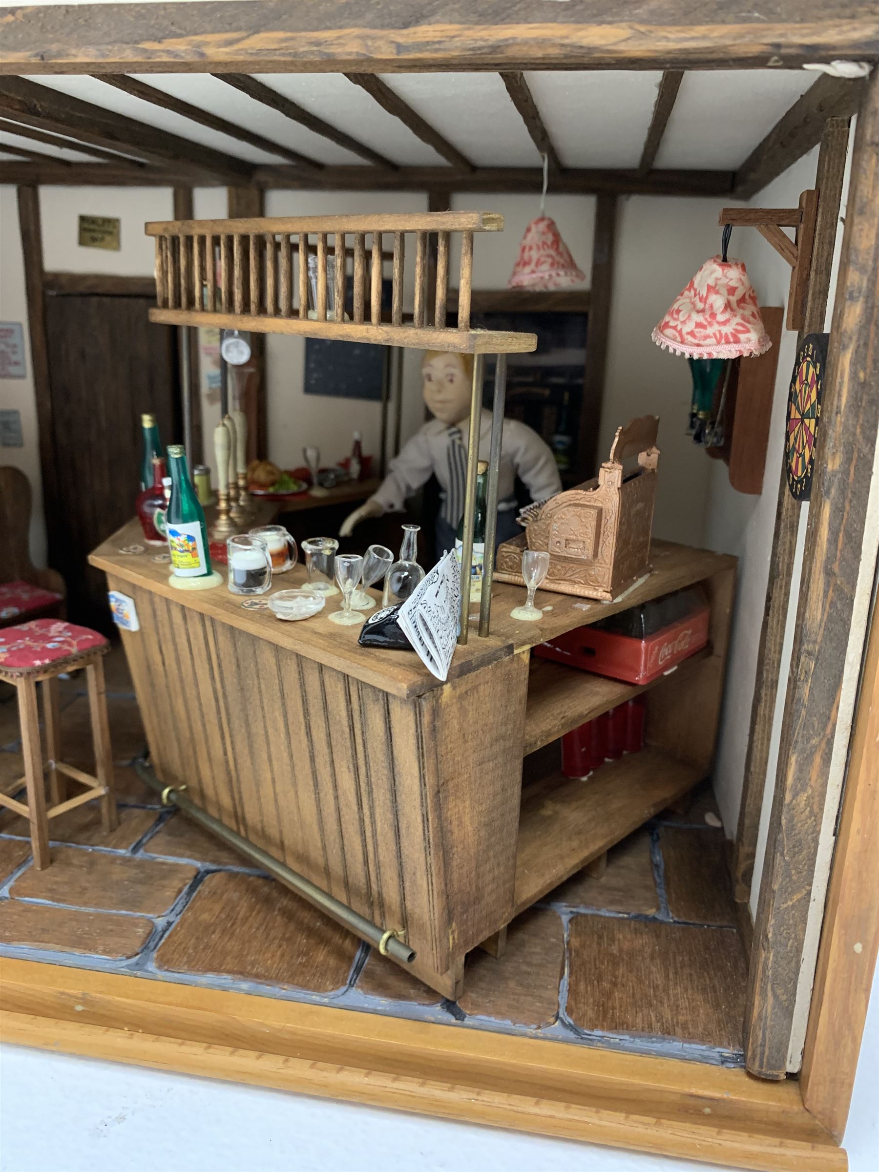 Dolls house scale room setting of a public house bar with tiled