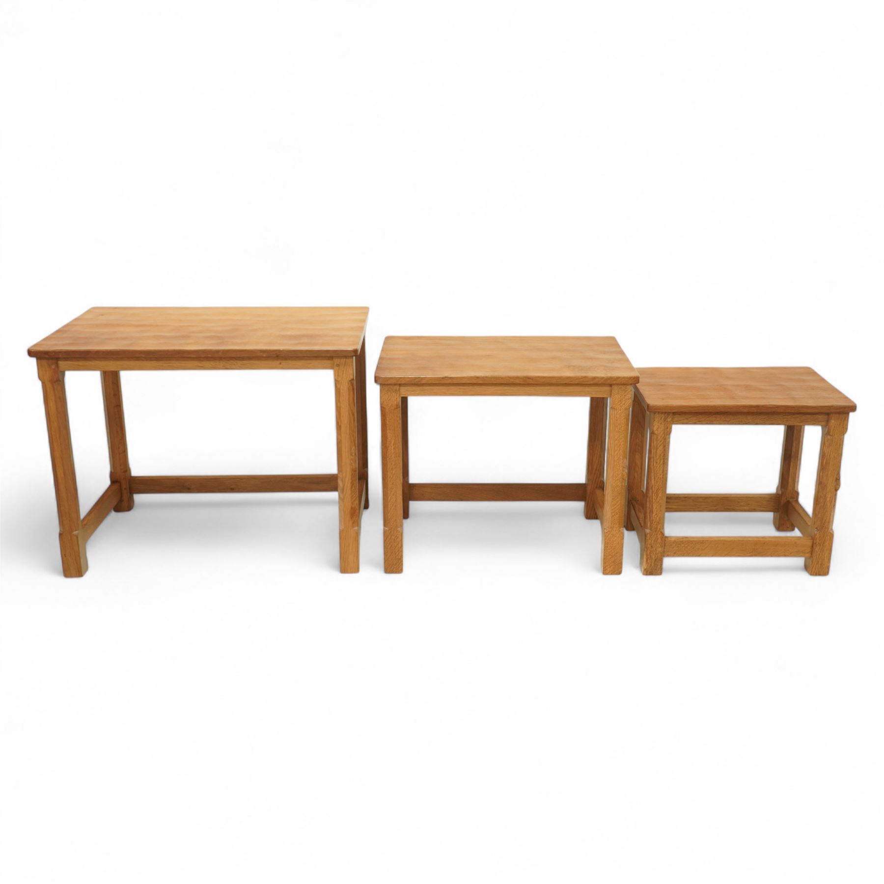 Mouseman - nest of three oak occasional tables, rectangular adzed top, on octagonal supports united by plain stretchers, each carved with mouse signature, by the workshop of Robert Thompson, Kilburn 