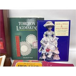 Collection of lace making wooden bobbins, together with lace making books and a handmade storage box