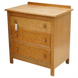 Arts & Crafts design limed oak bedroom suite; comprising dressing table, single wardrobe and chest, with carved scrolling motifs.

Wardrobe (H 181cm, D 47cm, W 79cm)
Chest (H 74cm, D 46cm, W 73cm)
Dressing table (H 136cm, D 47cm, W 74cm)