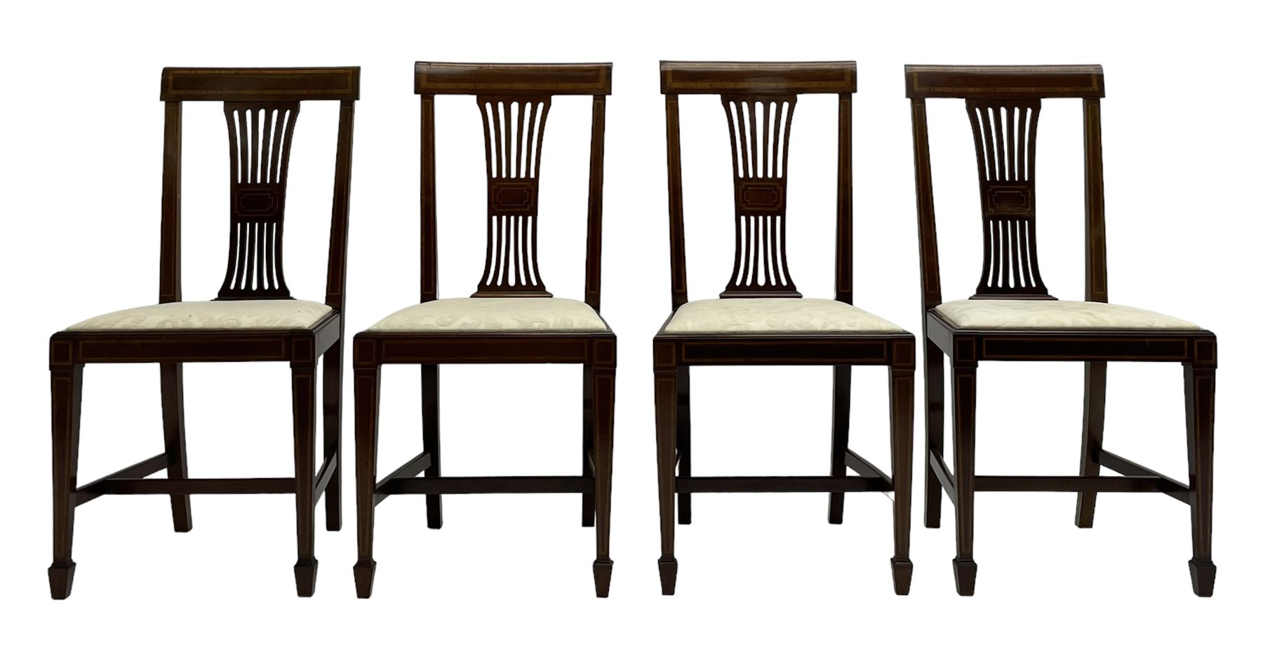 Set twelve (4+8) Edwardian inlaid mahogany dining chairs, cresting rail with satinwood banding, pierced splat backs with central inlay, drop-in seats upholstered in foliate patterned ivory fabric, raised on square tapering supports terminating in spade feet