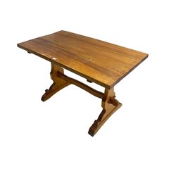 Traditional pine refectory design dining table, raised on shaped end supports with sledge feet, united by waived peg stretcher