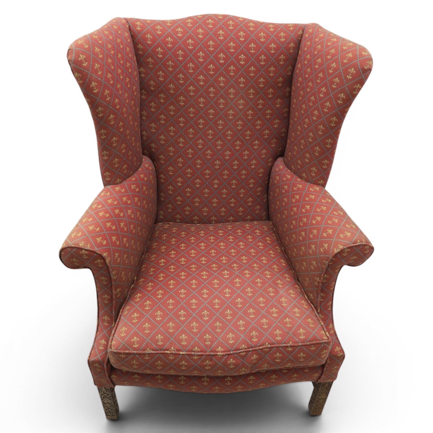 Georgian design wingback armchairs, the high backs flanked by shaped wings over padded scroll arms, upholstered in burgundy and gilt fleur-de-lys patterned fabric, loose cushion seats, raised on square tapering front supports