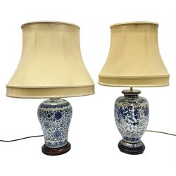 Two blue and white oriental style table lamps, both upon wood bases with matching fabric shades, tallest 33cm excl fitting