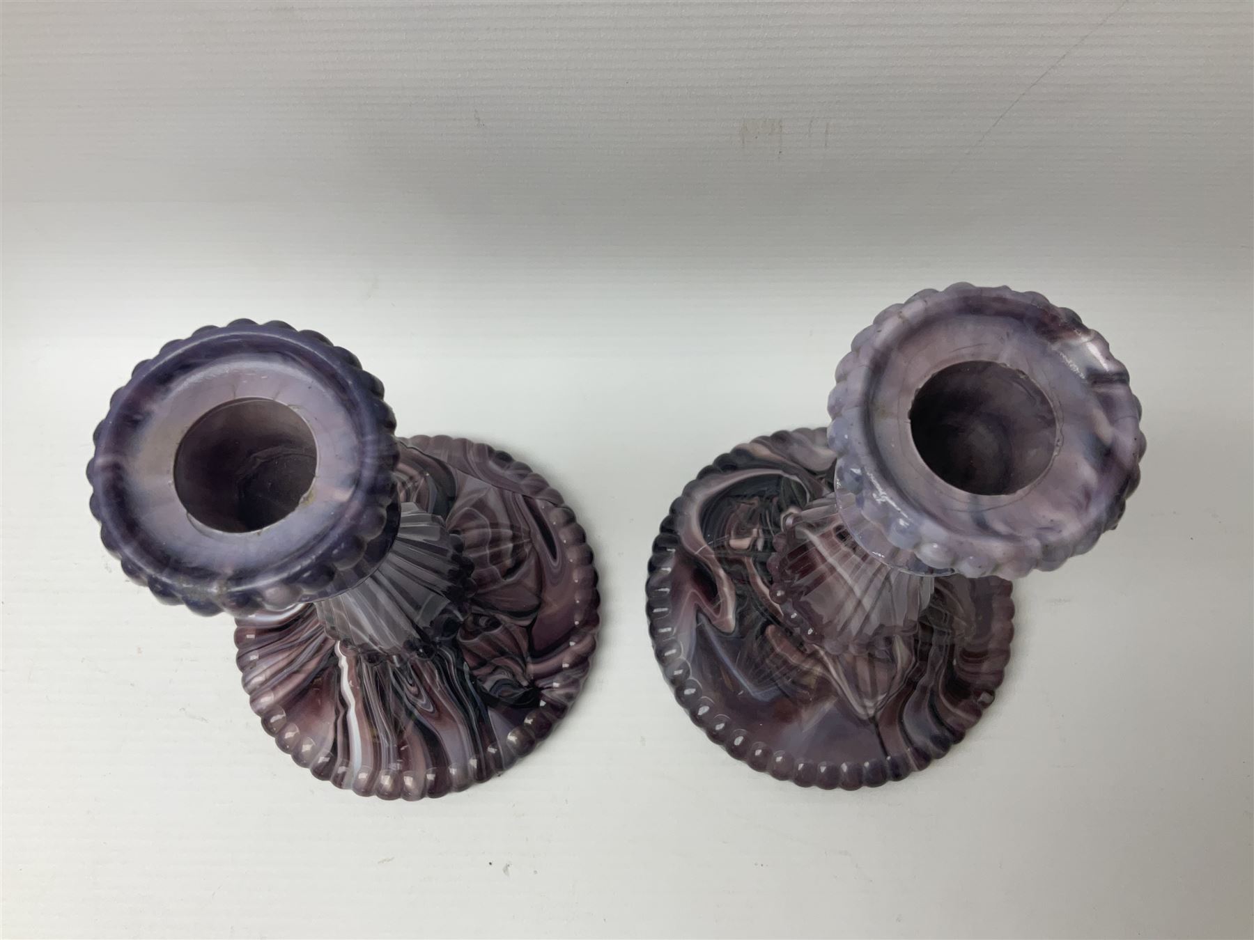Daum glass two stemmed candle stick signed to verso, together with a pair of slag glass purple candle sticks, Daum H21cm