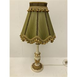 A cream and gilt finished table lamp, the turned base supporting a green pleated and tasselled shade, together with another similar small example, largest including shade, H85cm. 