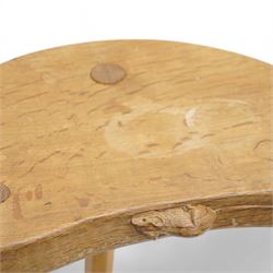 Mouseman - oak three-legged milking stool, dished kidney-shaped seat carved with mouse signature, on three octagonal tapered supports, by the workshop of Robert Thompson, Kilburn