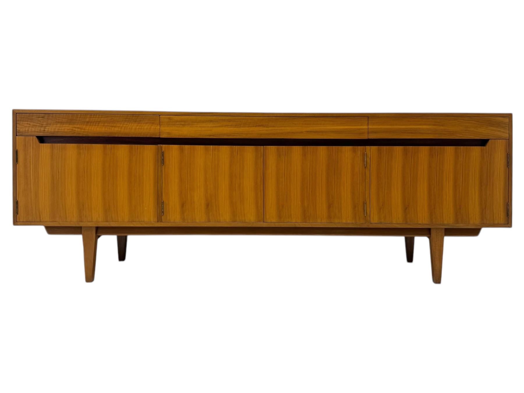 Younger - 1960s teak sideboard, three drawers over three cupboard, centre draw lined with baize with dividers, recessed handles with tapered feet