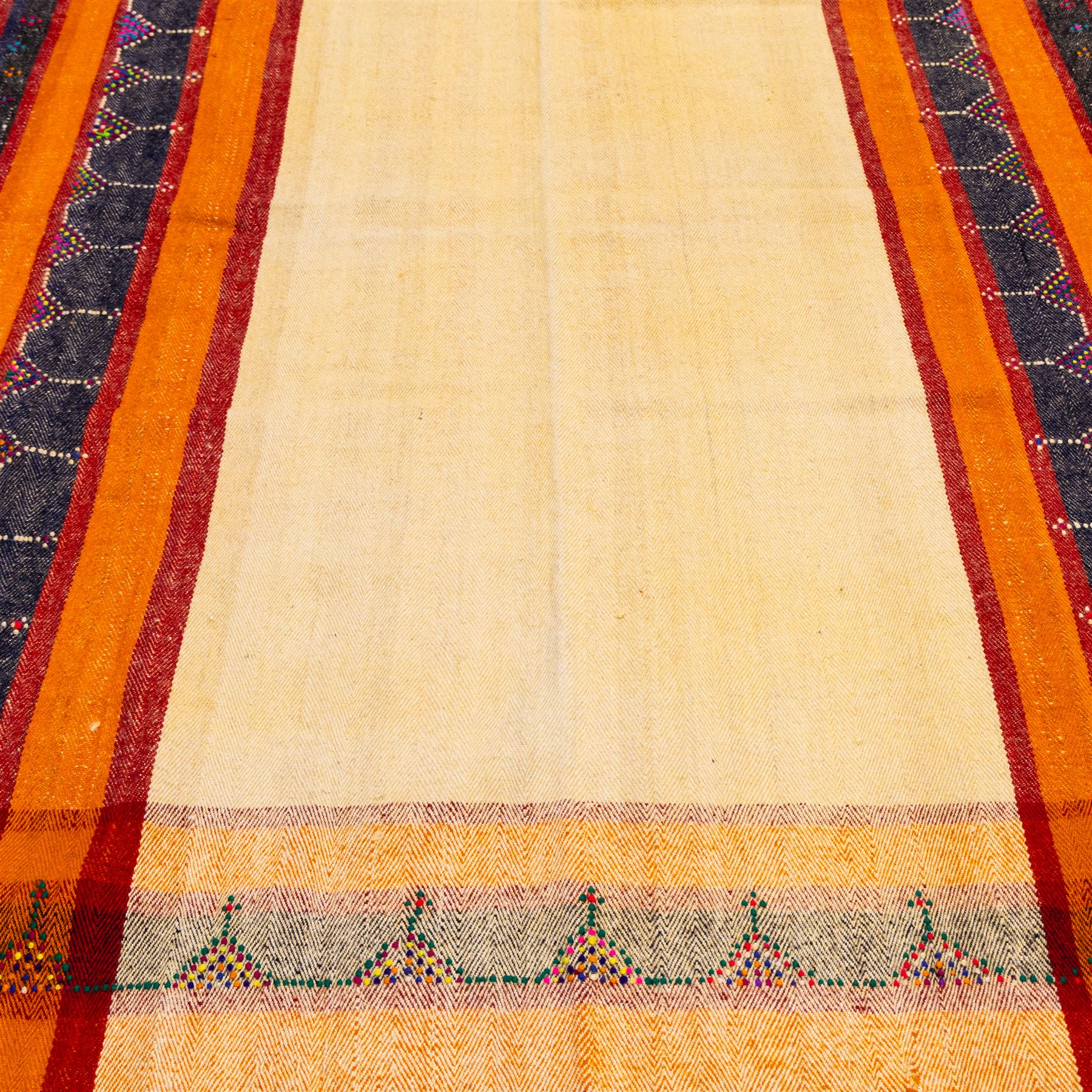 South West Persian Jajim kilim, central ivory field flanked by vertical bands of terracotta orange and dark brown decorated with simple geometric tribal motifs with raised wool pile details, edges finished with small coloured tassels 