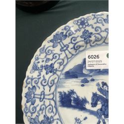 Chinese Kangxi style blue and white plate, decorated to the centre with a hunting scene  of two hunters on horse back, surrounded by a foliate boarder, with with six character double ring mark beneath