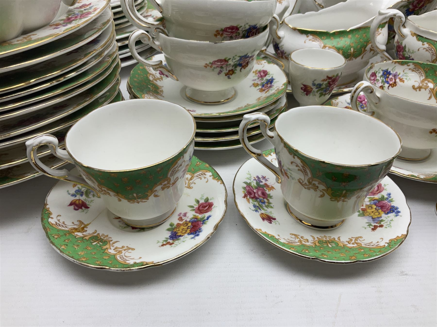 Paragon Rockingham pattern part tea and dinner service including three teapots, milk jug, cups and saucers of various sizes, ten soup bowls, ten side plates, ten dinner plates etc (96)