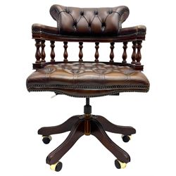 Mahogany framed swivel Captains desk chair, upholstered in brown buttoned leather, turned supports and swivel base on castors