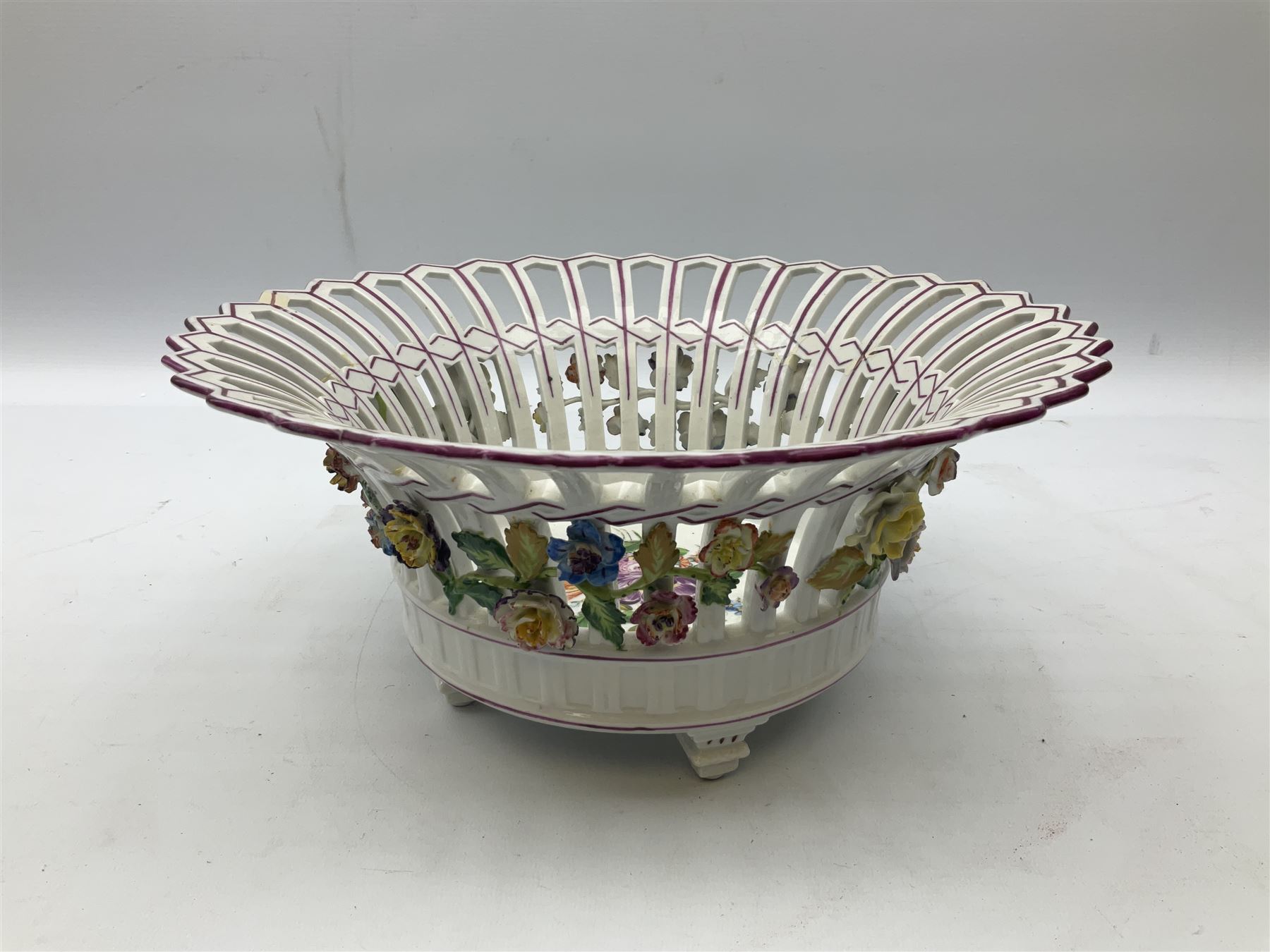 Early 20th century Dresden floral encrusted pierced bowl, centrally painted with flowers, on four tapering supports, D30cm 