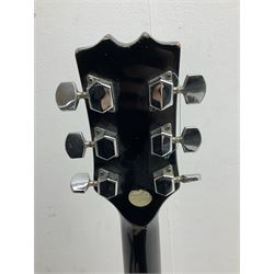 Stagg heavy metal style six-string electric guitar, finished in black with chrome tuning pegs, fret markers and humbucker pickups to bridge L106cm; and Hondo USA electric guitar with black body, ivory coloured pickguard and mother-of-pearl fretmarkers L101cm (2)   