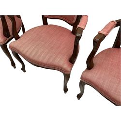 Set four French style stained beech elbow chairs, the cresting rails carved with flower heads, mould arms with scrolled terminals, upholstered in pink herringbone fabric, floral carved cabriole supports