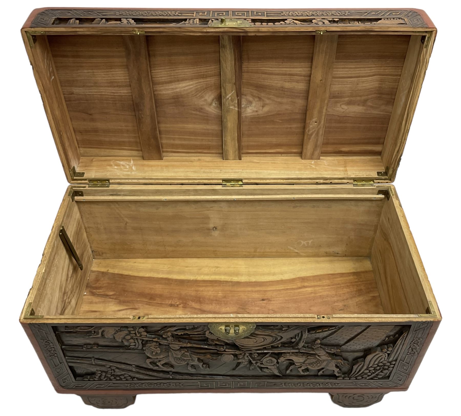 Mid-20th century Singapore camphor wood blanket chest, heavily carved depicting battle scenes and cityscapes 