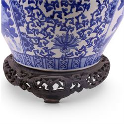 20th century blue and white fishbowl planter, decorated with birds in blossoming branches, internally decorated with goldfish, upon a wooden base, H44cm