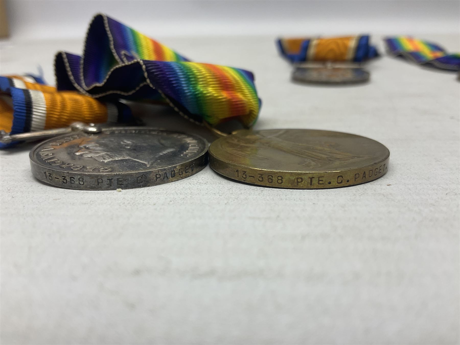 Family group of five WW1 medals for the East Yorkshire regiment comprising trio of 1914-15 Star, British War Medal and Victory medal awarded to 13-368 Pte. C. Padget; and British War Medal and Victory Medal to 201829 Pte. H.W. Padget; all with ribbons (5)