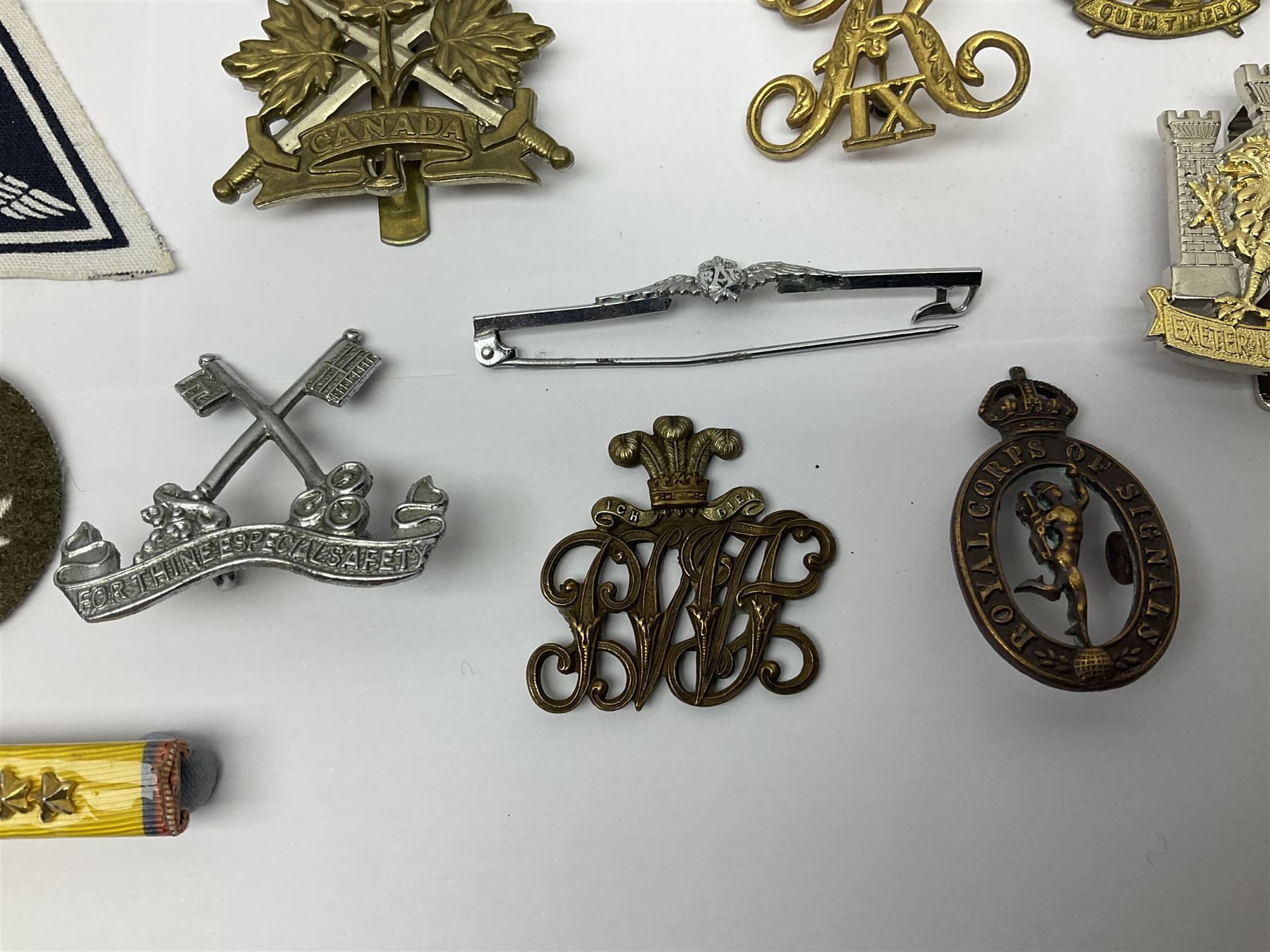 Collection of approximately sixty worldwide medals, metal badges, belt buckles, cloth badges, trench art, brass button stick etc