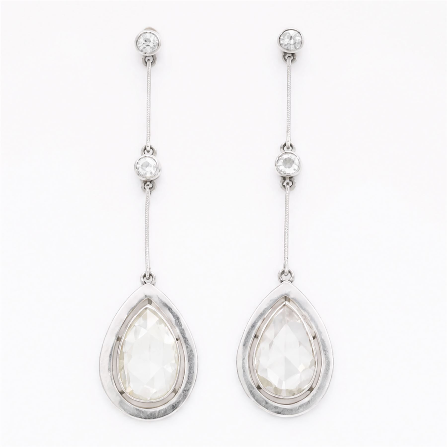 Platinum diamond modernist pendant stud earrings, set with a single rose pear cut diamond of approx 1.00 and 1.20 carat each, suspending from two milgrain set old cut diamonds, to screw back settings, total diamond weight approx 2.40 carat