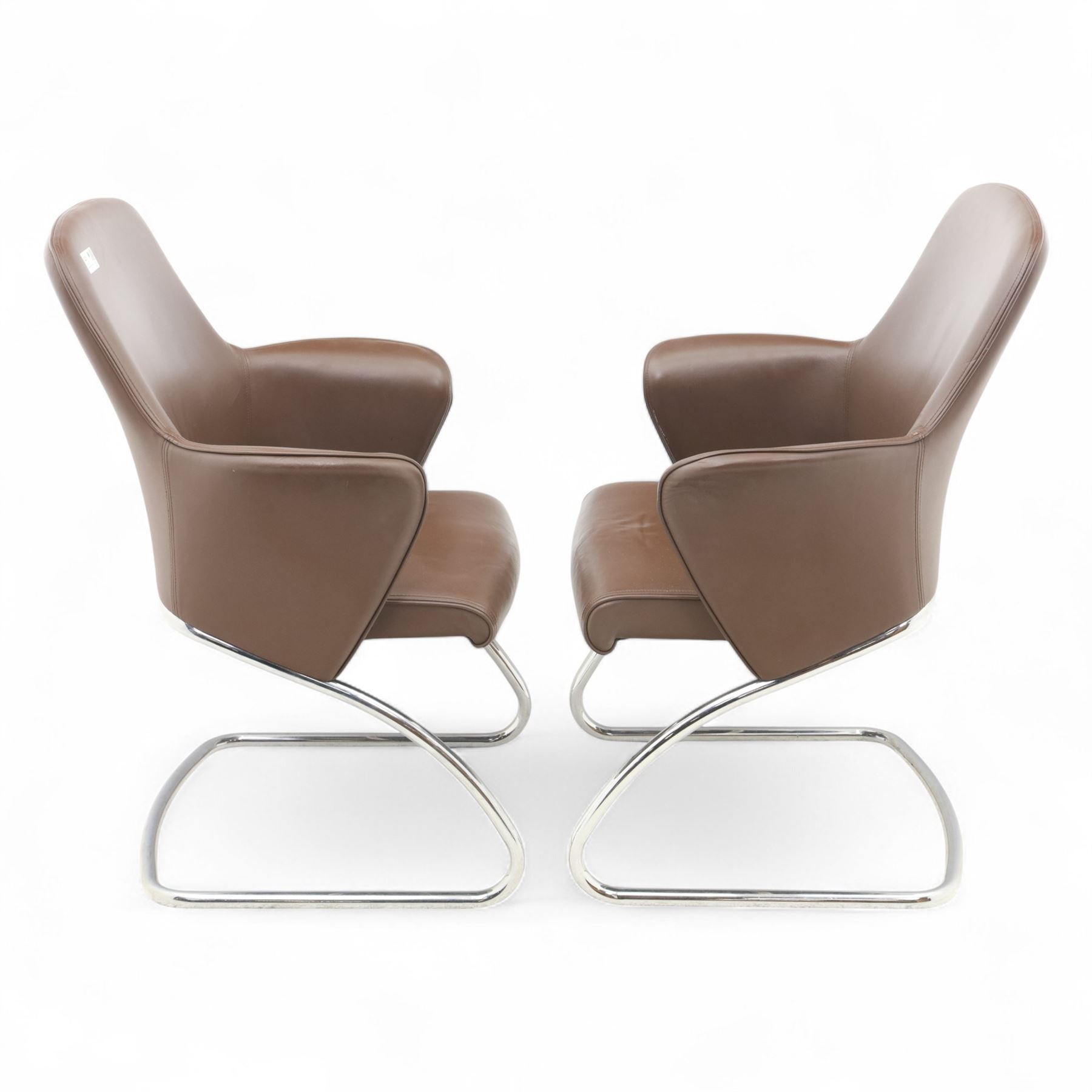 Two Senator executive cantilever chairs, upholstered in Padova hide, moulded back and integrated armrests, raised on a tubular chromed cantilever base