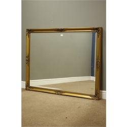  Large bevelled edge wall mirror in swept gilt frame, 135cm x 105cm  