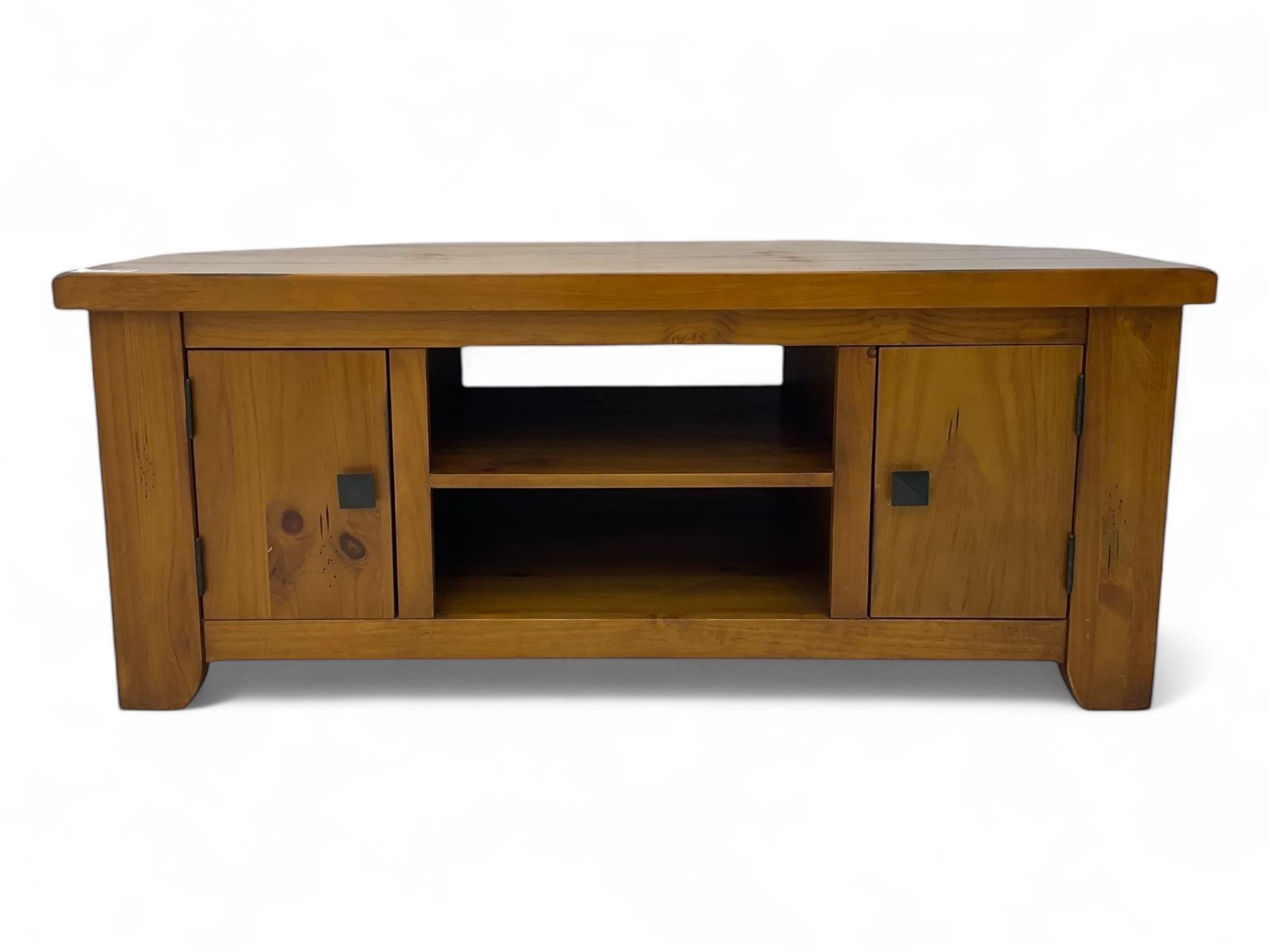 Contemporary mango wood television stand, wide planked surface and angled back corners, central shelving section flanked by twin cupboard doors with square pull handles, raised on stile supports