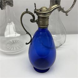 Silver plate mounted blue glass claret jug of ovid form, with C scroll handle, together with two other silver plate mounted claret jug