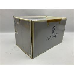 Lladro figure, The Loaves and Fishes, modelled as Jesus Christ with arms raised standing beside a basket of loaves and a basket of fish, sculpted by Salvador Furió, with original box, no 5896, year issued 1992, year retired 1997, H35cm