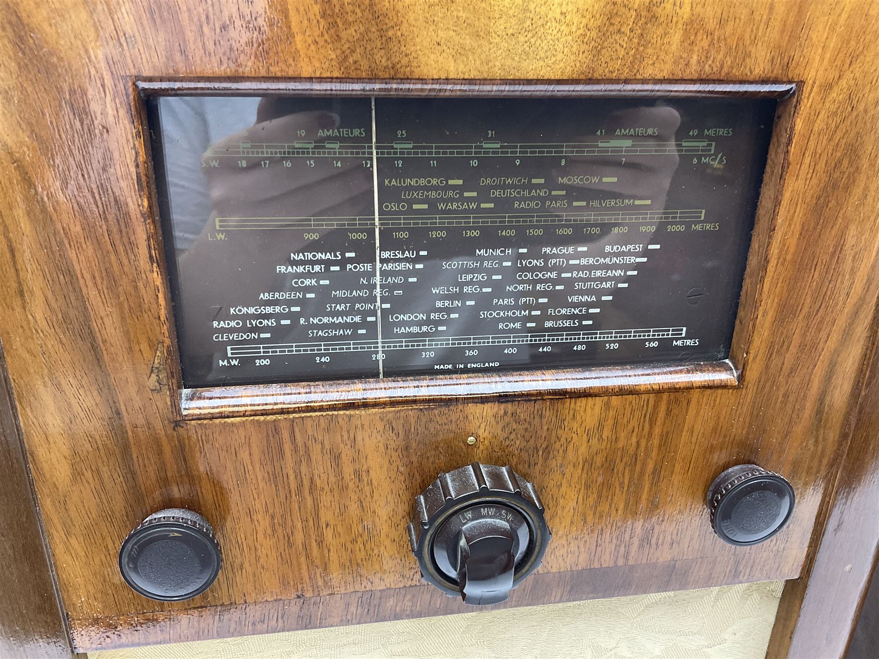 1950s Bush AC41 mahogany cased valve radio, 1930s Philips 588A with walnut veneer case, and 1940s Cossor Model 77, tallest H47cm W36cm D24cm