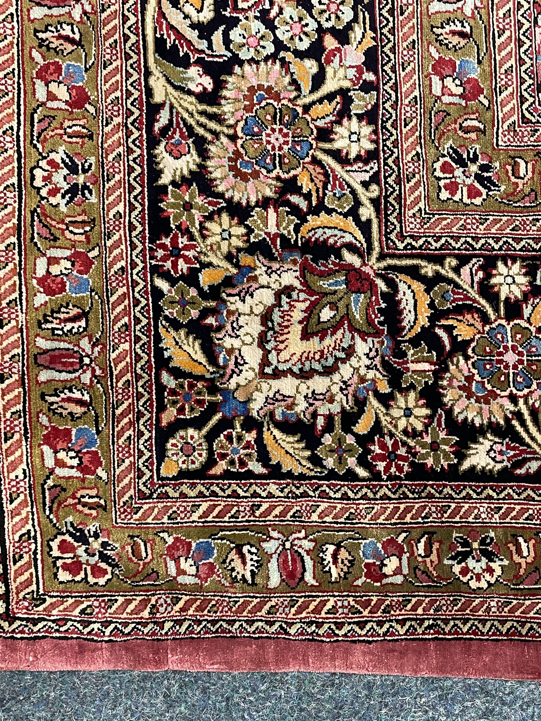 Finely knotted Persian Qom silk rug, overall pink ground with ivory field, the field with central cusped medallion profusely decorated with interlacing foliate and stylised flower heads, multiple band boarder, the main band decorated with a series of stylised motifs and trailing foliage, the outer guard with signature panel 