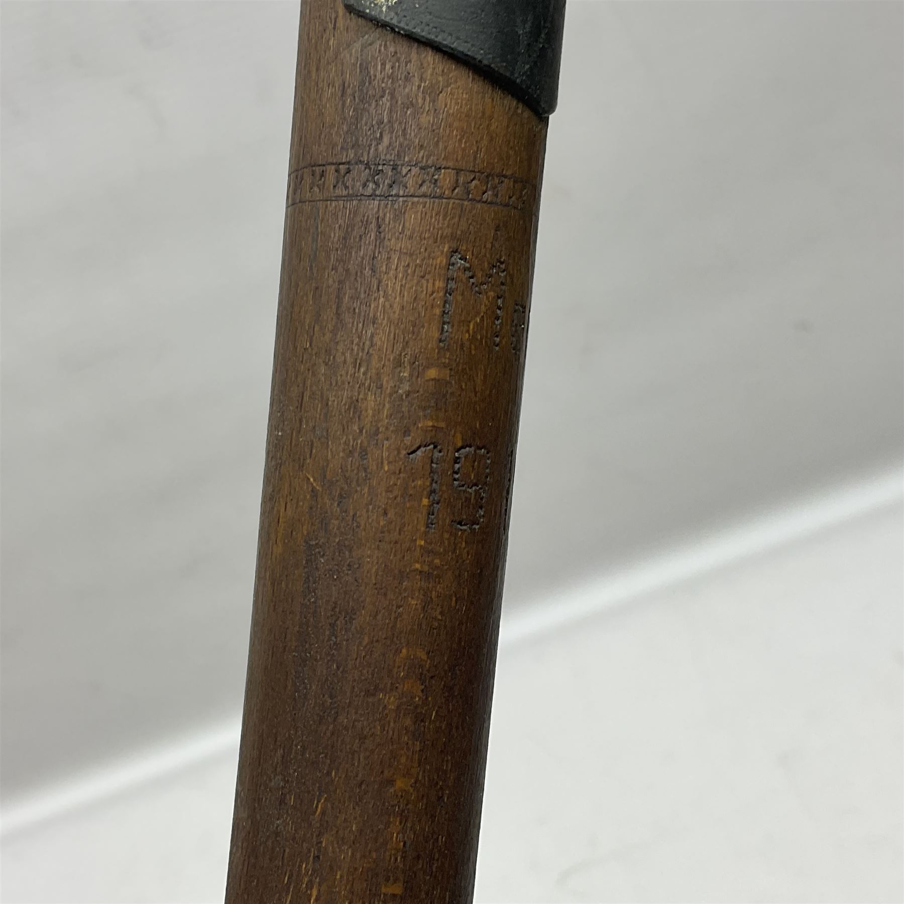 WW1 Prisoner of War carved beech walking cane, the terminal as a head wearing a helmet, and inscribed 'Souvenir from 370th PoW Coy Menin 1919'; bears metal plaque with indistinct monogram L91cm