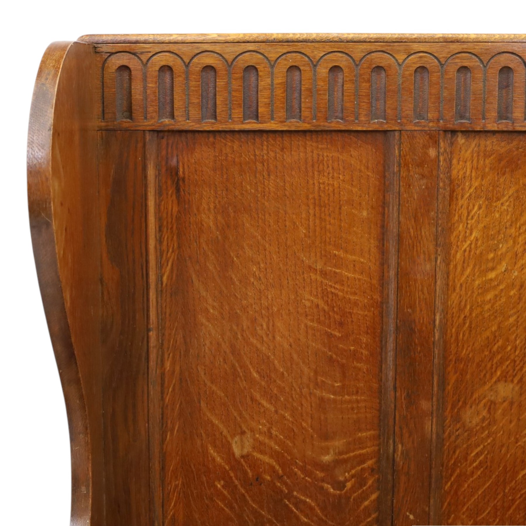 Early 20th century oak box settle, panelled back with arcaded carved rail, swept sides and arms, hinged seat with storage, panelled front