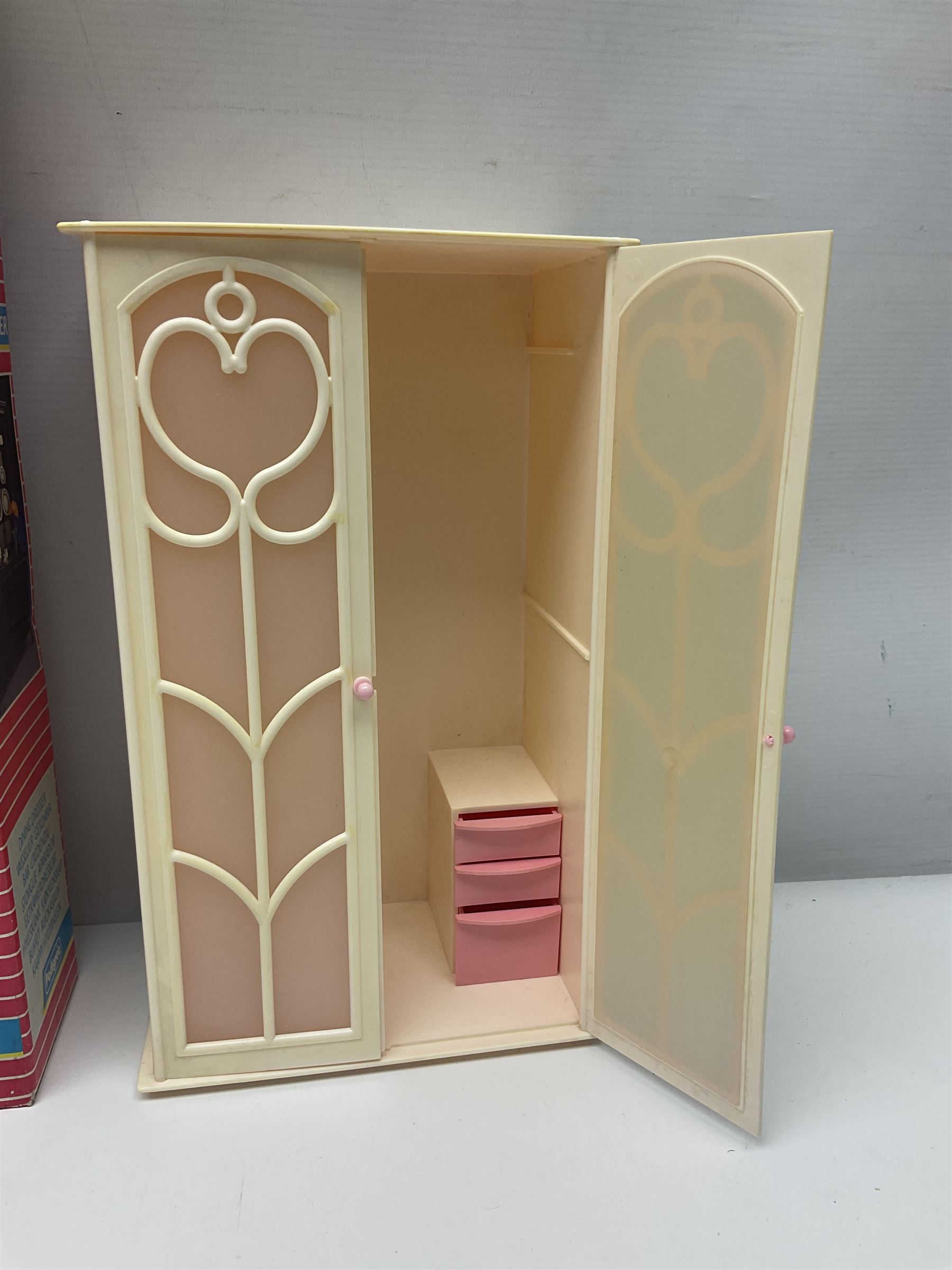 Sindy - furniture and accessories comprising dining suite with separate dresser; two beds; Garden Set; Music Centre; all  boxed; three-piece bedroom suite; settee; Hostess Trolley; two coffee tables; and four-piece bathroom suite including shower cubicle