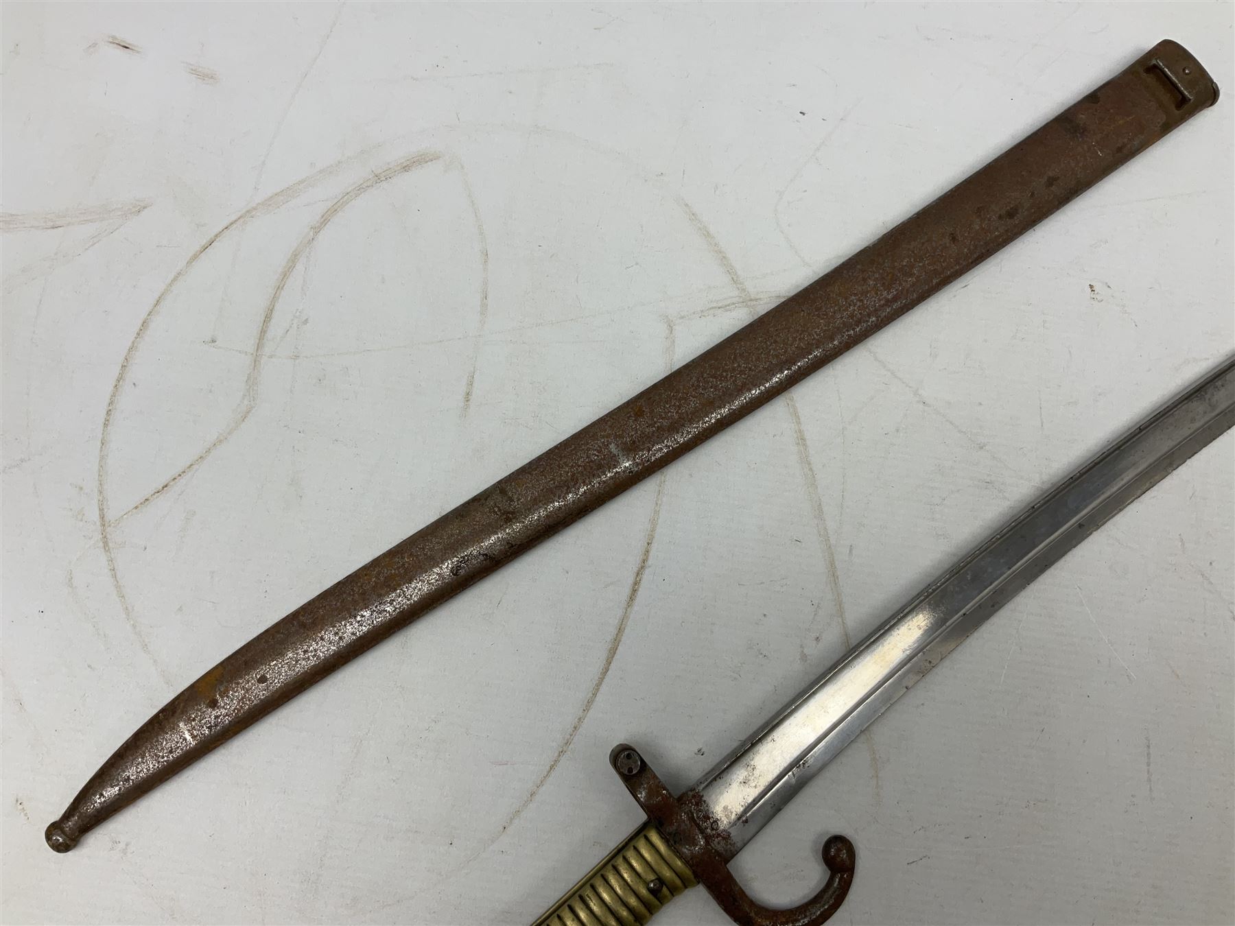 French model 1866 sabre bayonet, the 57.5cm curving blade marked St. Etienne 1873; in associated steel scabbard L71cm; and Mosin-Nagant M1891 socket bayonet with 43cm cruciform blade No.37068 (no scabbard) (2)