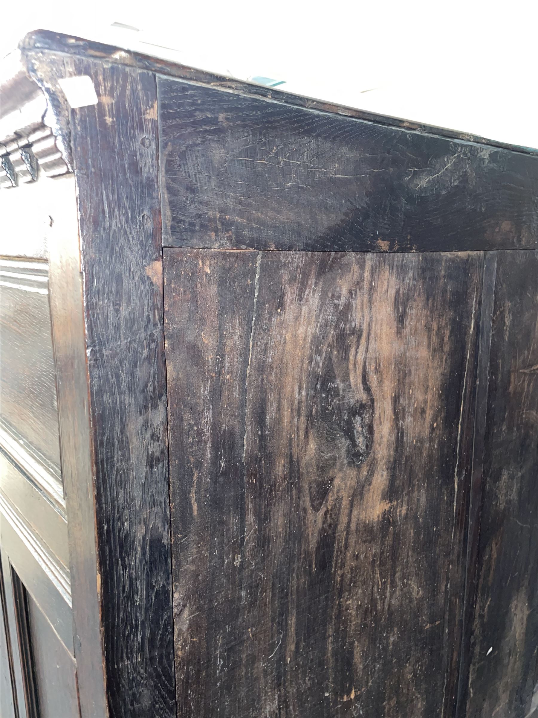 17th century oak chest on stand, moulded cornice over block work frieze, the upper section fitted with three long drawers each decorated with applied geometric mouldings and faceted panels, panelled sides with moulded frame, the stand fitted with two drawers, on five turned supports united by plan flat stretchers, terminating to turned feet