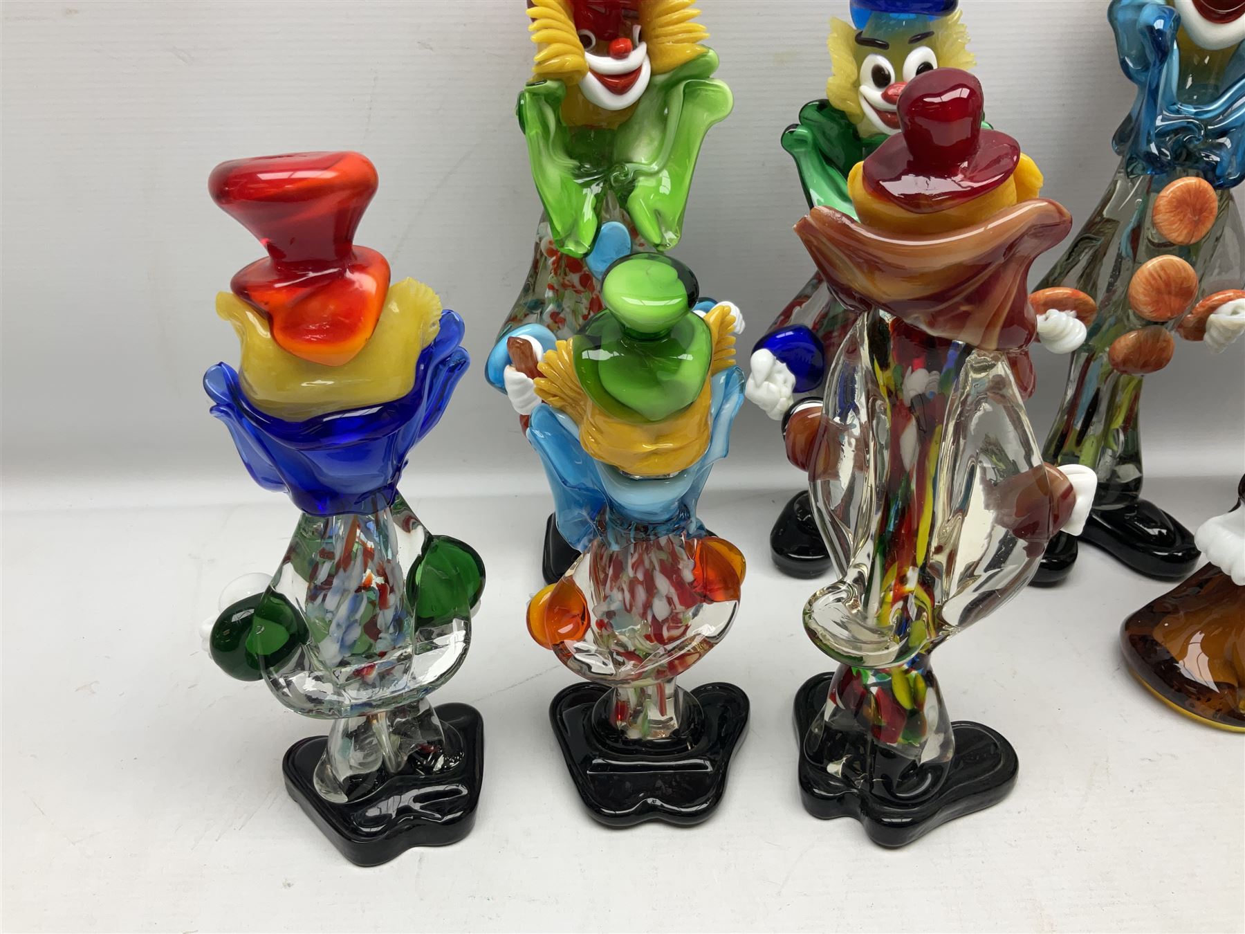 Large quantity of Murano glass clowns, to include larger examples, in two boxes