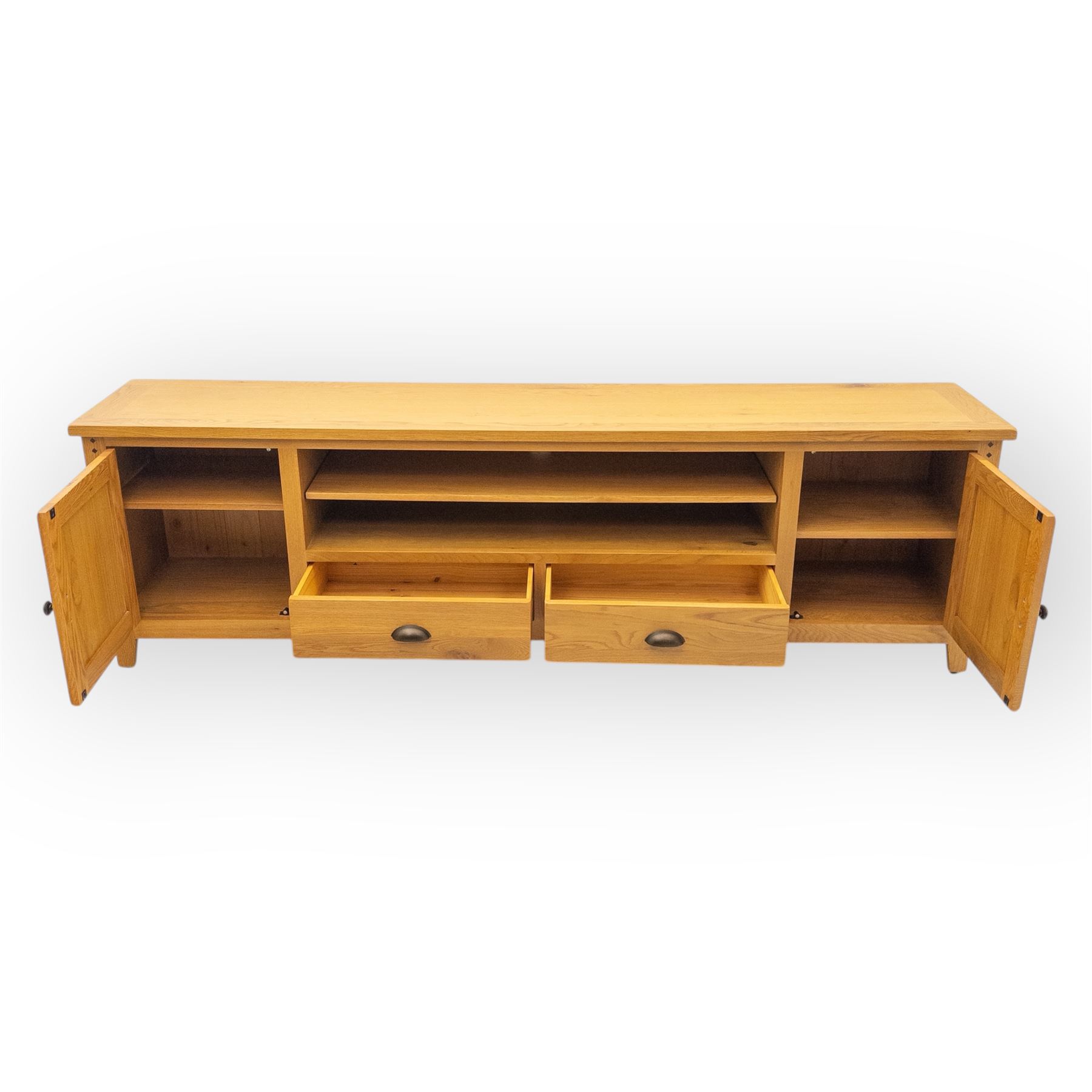 Cotswold & Co - large light oak media stand, rectangular top above central open shelf, double drawer flanked by two panelled cupboard doors, fitted with metal cup and knob handles