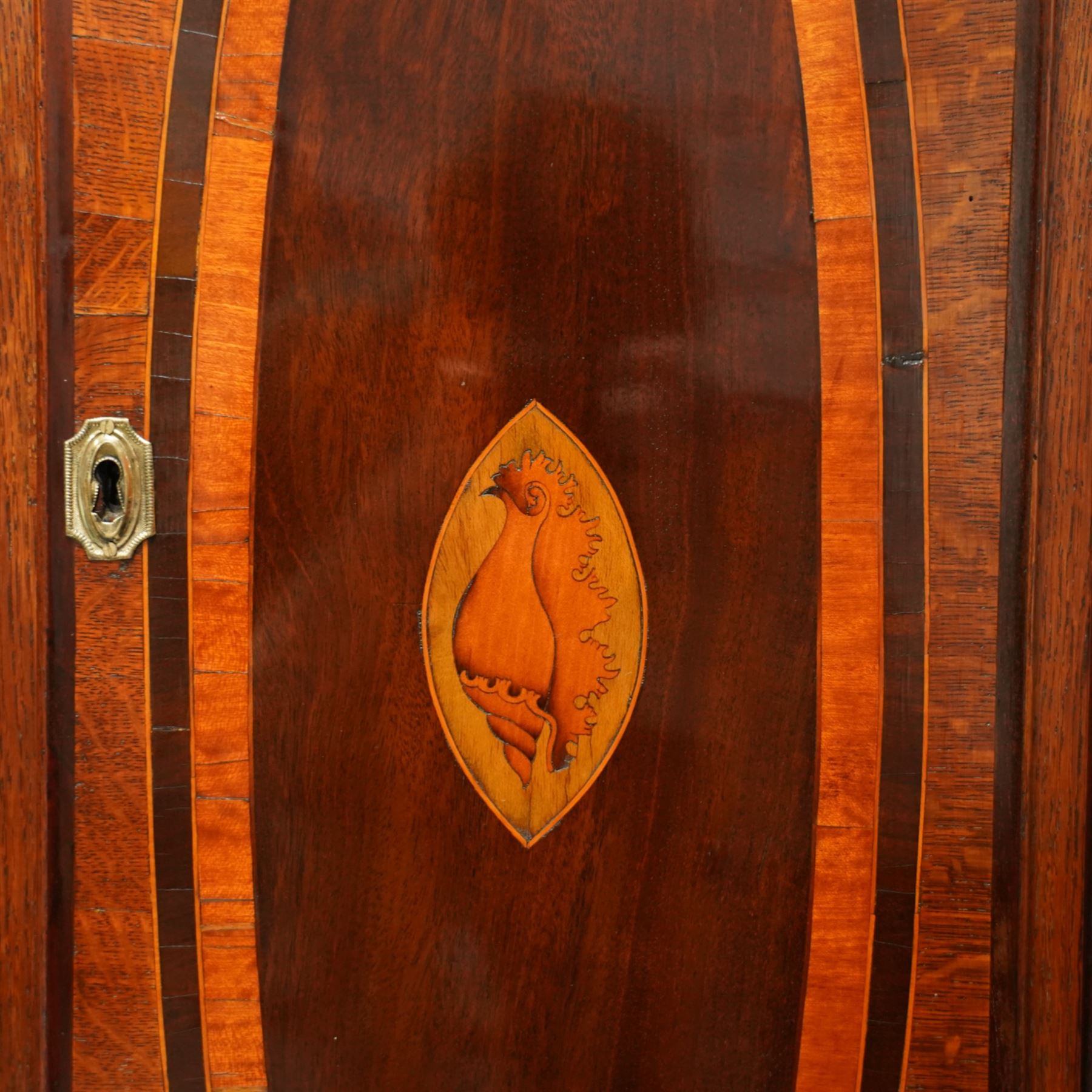 William Vise of Wisbech (Cambridgeshire)-8-day mahogany Longcase clock c1750, with a swan neck pediment and inlaid parterre, break arch hood door beneath flanked by detached reeded pilasters with brass capitals, trunk with conforming pilasters to the corners and an inlaid door with banding to the edge and oval satinwood inlay and matching conche inlay to the centre, conforming pediment with matching circular inlay and raised on bracket feet, brass break arch dial with interesting scroll and floral spandrels to the arch and four season spandrels to the corners, fully engraved dial centre with steel hands, engraved seconds dial and square date aperture, silvered boss to the arch with makers name and conforming chapter with Roman numerals, five minute Arabic's and minute track, dial pinned directly to a two train weight driven rack striking movement, sounding the hours on a bell. With weights and pendulum. 
Both a William and John Vise are recorded as working in Wisbech between 1740 and1758.