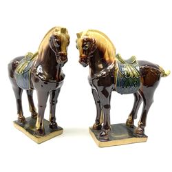 A pair of glazed pottery Tang style horses, each with impressed marks beneath, each approximately H25.5cm. 