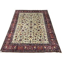 Kashan beige ground rug, trailing foliage field, red border with repeating pattern