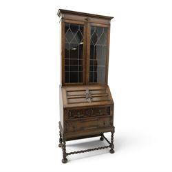 Early 20th century Jacobean Revival oak bureau-bookcase, astragal glazed doors enclosing t...