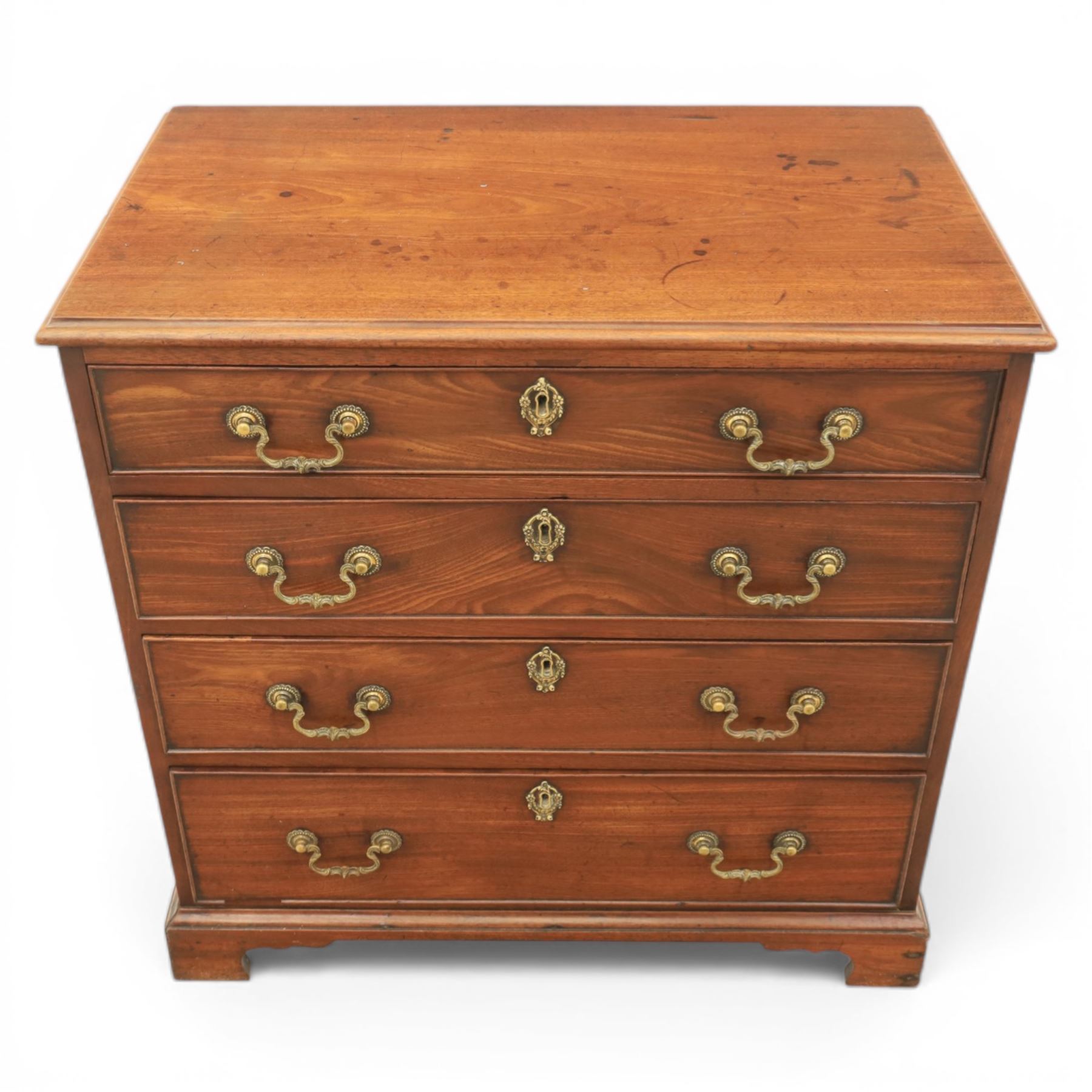 Georgian mahogany dwarf chest of drawers, the moulded rectangular top over four graduated drawers, fitted with brass drop handles, upon shaped bracket feet