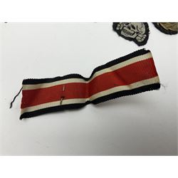 Collection of eleven German metal and cloth badges and uniform buttons including driver's badge, two 'SS' fabric skulls, private's shoulder tabs, Police cloth badge, tank destruction badge, medal bars and ribbon etc; most WW2 period