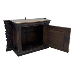 18th century and later carved oak cupboard, enclosed by panelled door carved with central bird motif and scrolled leafage with an outer ebony band, the frieze and uprights carved with repeating lunette and floral designs, flanked by scrolled foliate carved upright brackets