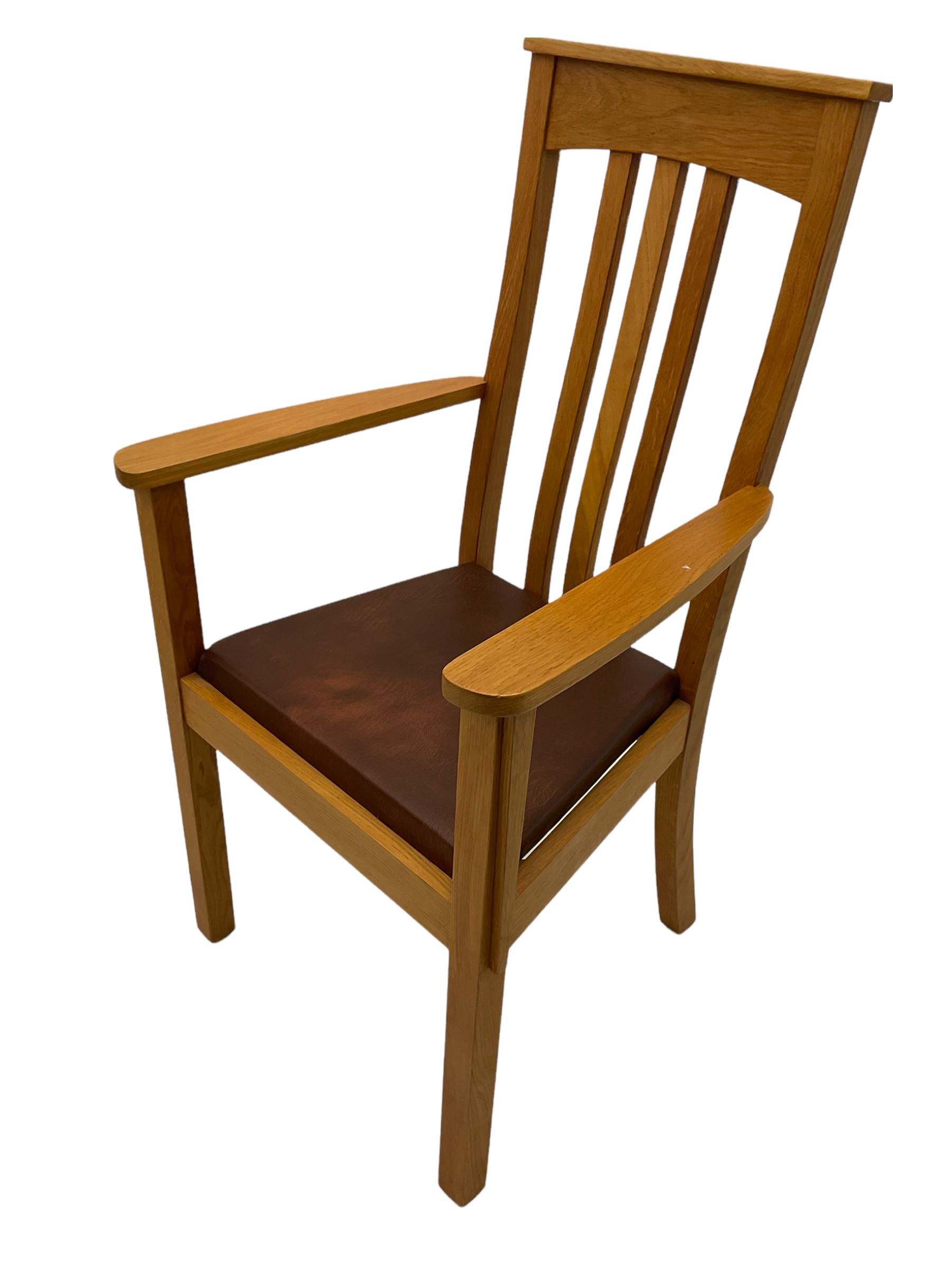 Pair of solid oak Arts and Crafts style carver chairs, inlay to top rail, drop in seat