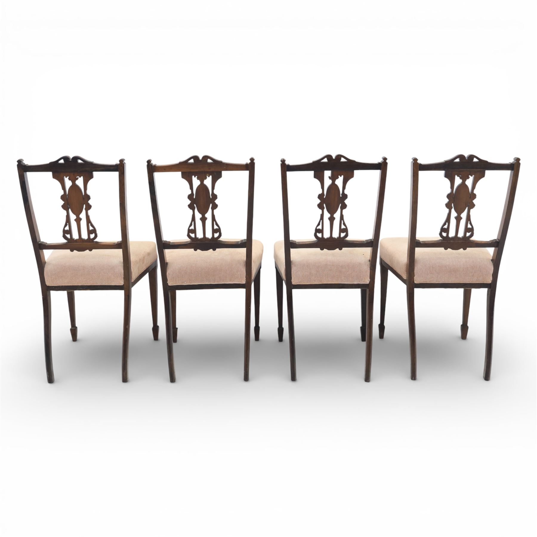 Quality Edwardian seven piece inlaid salon suite, comprising three seater settee, pair of arm chairs and four chairs with pierced splat backs, upholstered in pale pink fabric, inlaid with flowering urns, upon tapering legs with spade feet and castors