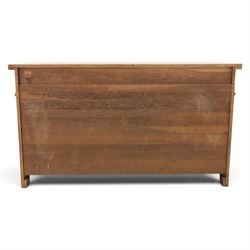 Indigo Furniture - large rustic oak sideboard fitted, with three drawers above three central drawers, flanked by fielded panelled doors, raised on bracket feet