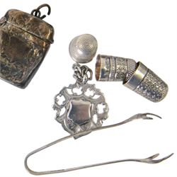 Group of silver, including three napkin rings, three spoons, sugar tongs, three thimbles, vesta case, chain and fob, together with a collection of coins
